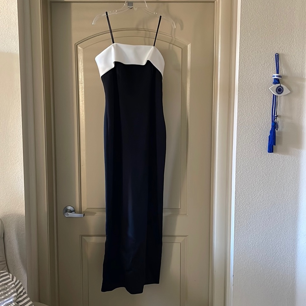 Black and white satin column dress with spaghetti straps and back slit.